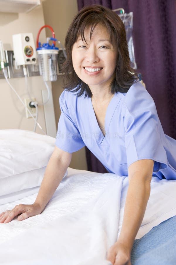 A Nurse Making A Bed Smiling royalty free stock photos