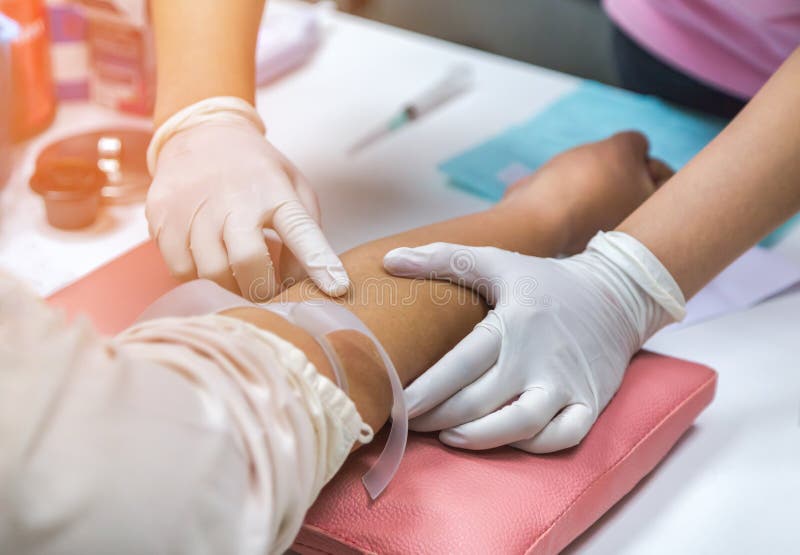 Nurse Preparing Injection To Patient`s Arm for Blood Drawing Sample for
