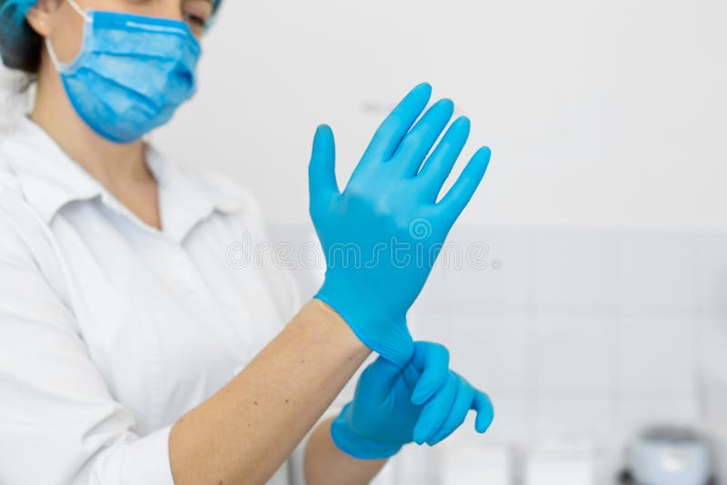 Nurse in Scrub and Mask Puts Gloves on Her Hands Stock Photo Image of operation, female 155173478