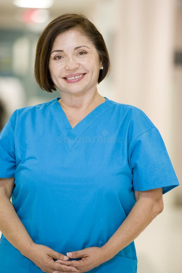 Nurse In Scrubs Standing In A Hospital Corridor