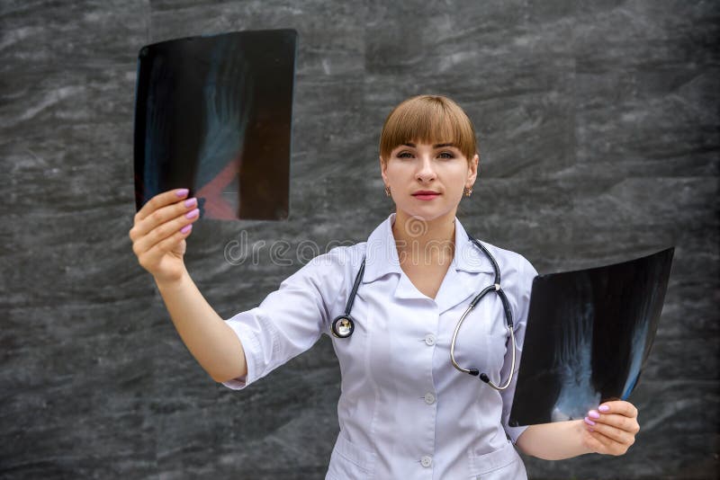 Nurse student examines X-ray of foot. Medical concept royalty free stock photos Nurse student examines X-ray of foot. Medical concept royalty free stock photos