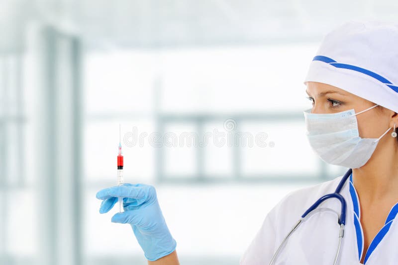 Nurse with a syringe in his hand.