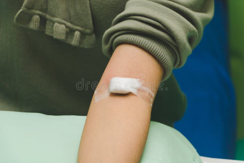 The nurse takes the patient`s blood with a syringe. Nurse takes the patient`s blood with a syringe. She had a blood clot in her arm with a cotton swab off the royalty free stock image The nurse takes the patient`s blood with a syringe. Nurse takes the patient`s blood with a syringe. She had a blood clot in her arm with a cotton swab off the royalty free stock image