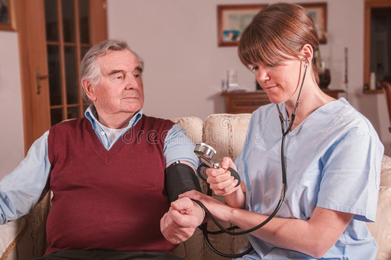 Nurse taking blood pressure at home royalty free stock photo Nurse taking blood pressure at home royalty free stock photo