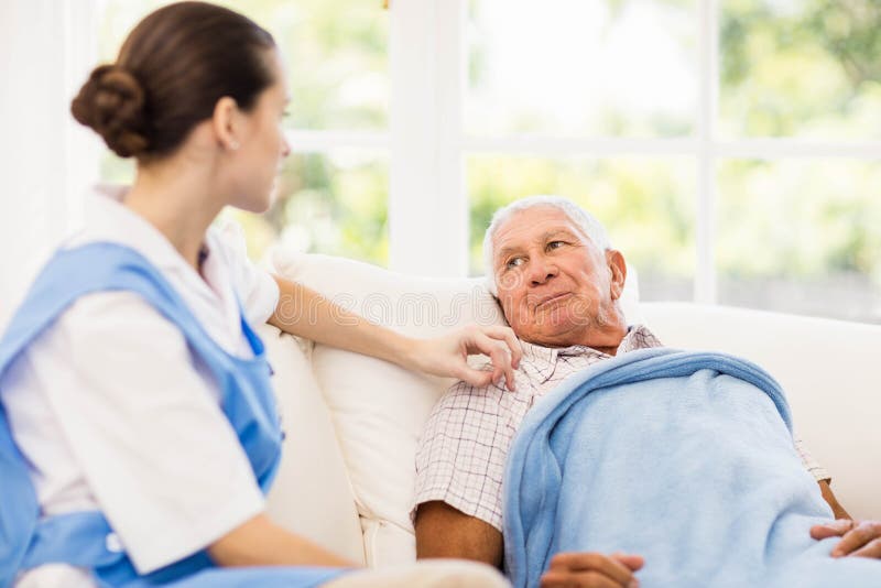 Nurse taking care of sick elderly patient stock image Nurse taking care of sick elderly patient stock image