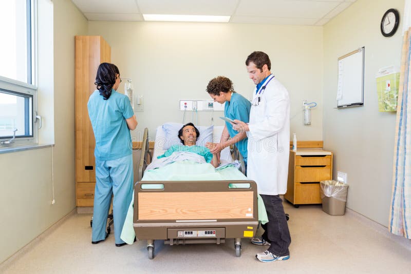 Nurses And Doctor Examining Patient In Hospital royalty free stock photography Nurses And Doctor Examining Patient In Hospital royalty free stock photography