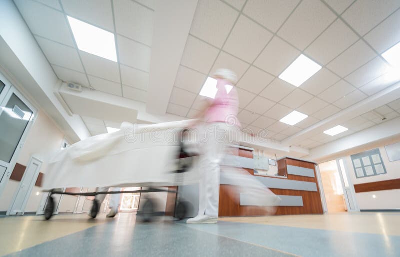 Nurses Moves Medical Stretcher with Patient at Hospital. Medical