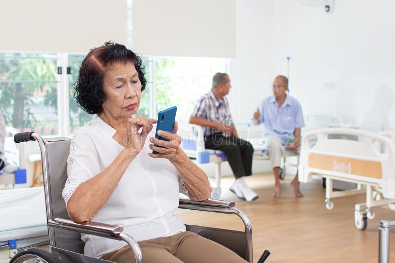Nursing Home Care Concept. Elderly Woman Using a Mobile Telephone