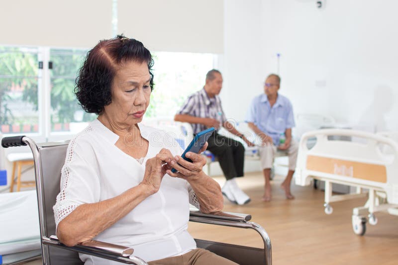 Nursing Home Care Concept. Elderly Woman Using a Mobile Telephone