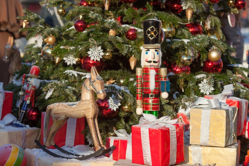 Nutcracker and wood horse at Christmas Market  in Winter Moscow, Russia. Advent Decoration and fir tree with Crafts gifts on the