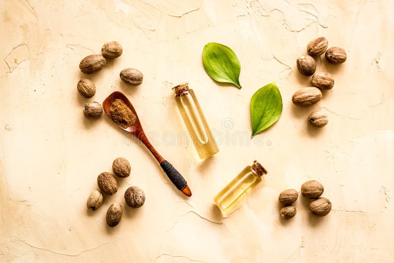 Nutmeg Oil Perfume Ingredient on Beige Background Topdown Stock