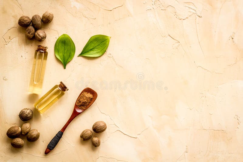 Nutmeg Oil Perfume Ingredient on Beige Background Topdown Copy