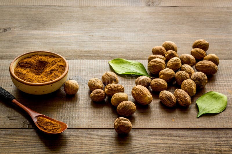 Nutmeg Oil Perfume Ingredient on Wooden Background Copy Space Stock