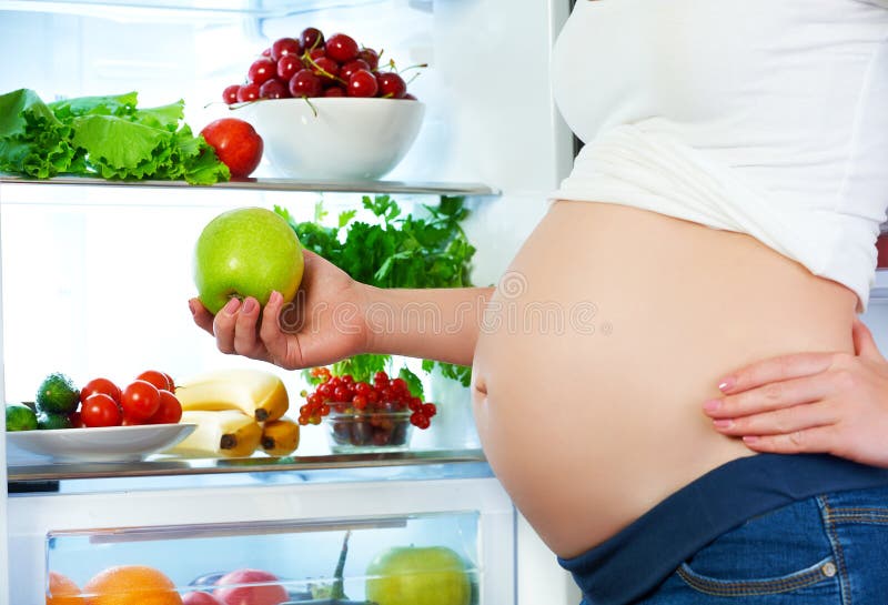 Nutrition and diet during pregnancy. Pregnant woman with fruits