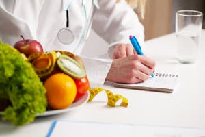 Nutritionist Prepares A Diet Plan For An Overweight Woman Stock Image