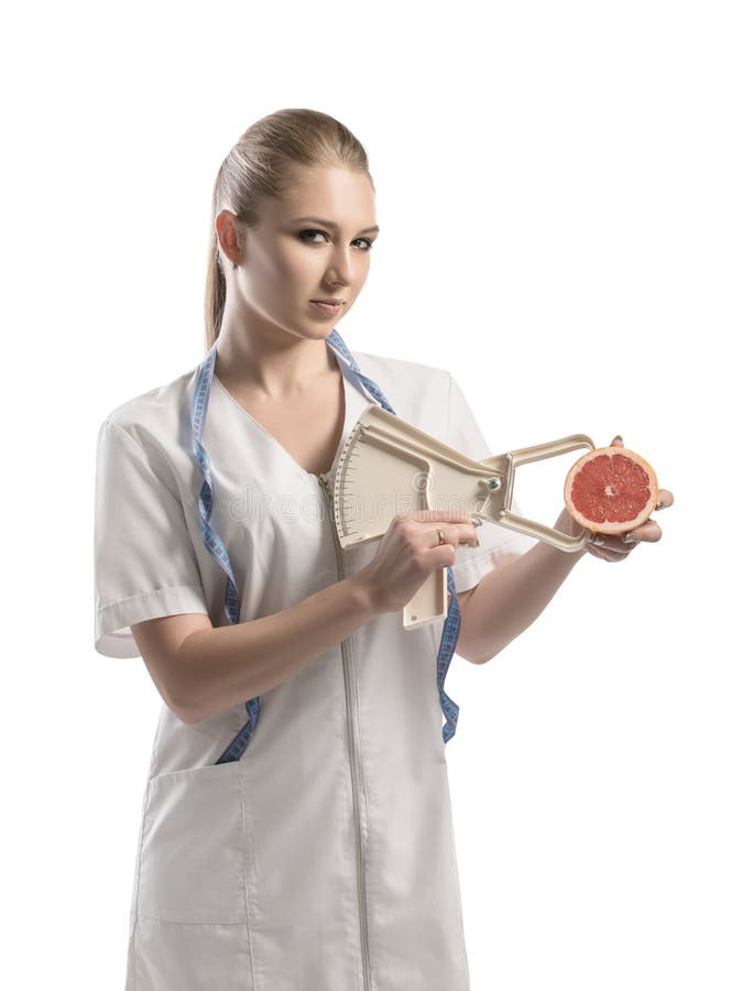 Nutritionist in white uniform with a tape-measure royalty free stock images Nutritionist in white uniform with a tape-measure royalty free stock images