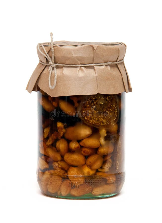 Healthy mix of natural honey with different nuts in a jar on white  background Stock Photo - Alamy