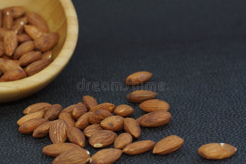 Nuts Mandeln gossen aus einer Bambusschüssel, auf einem dunklen Hintergrund heraus, gesunde Diät für Gewichtsverlust stockfoto Nuts Mandeln gossen aus einer Bambusschüssel, auf einem dunklen Hintergrund heraus, gesunde Diät für Gewichtsverlust stockfoto