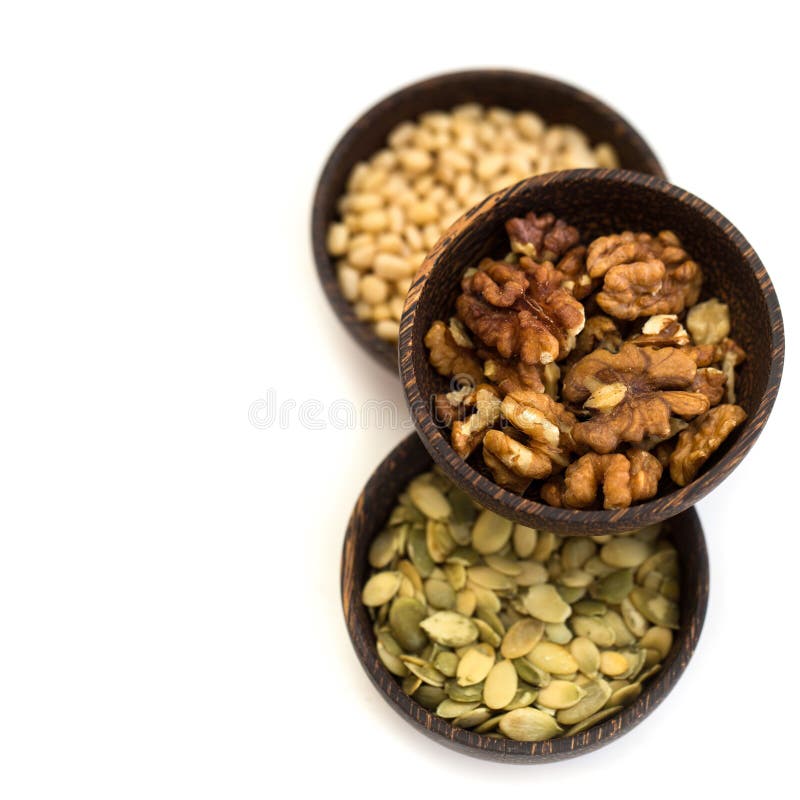 Nuts and pumpkin seeds in a wooden bowl