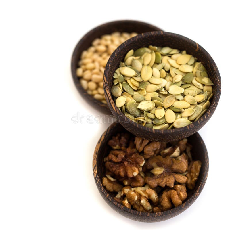 Nuts and pumpkin seeds in a wooden bowl