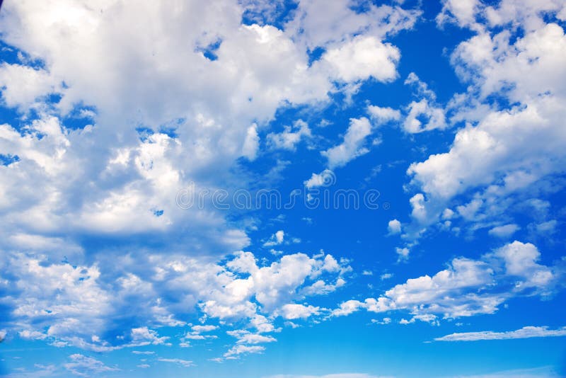 Delicate fluffy white clouds in the sunlight against a blue sky. Spring seamless summer background. Template for design. Light, gentle artistic image. Delicate fluffy white clouds in the sunlight against a blue sky. Spring seamless summer background. Template for design. Light, gentle artistic image.