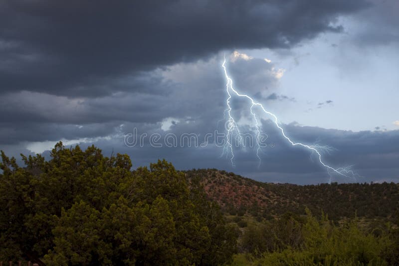 Gathering dark storm clouds with thunder and lightning from the skies. Gathering dark storm clouds with thunder and lightning from the skies