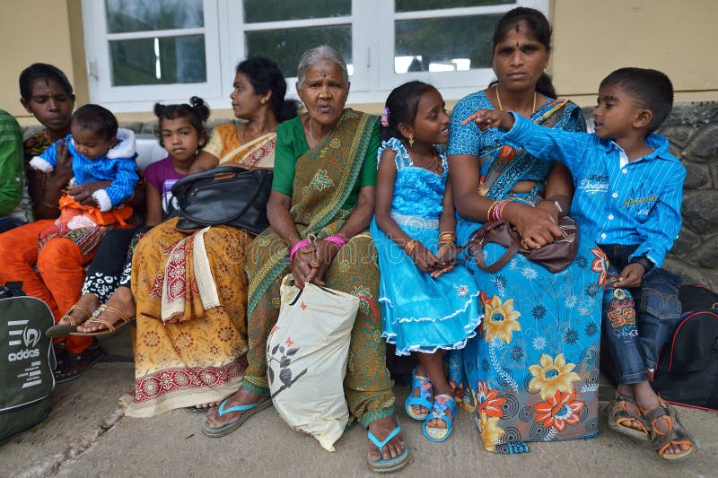 Nuwara Eliya, Sri Lanka, November 13, 2015: Women and kids waiting for the train on the train station of Nuwara Eliya