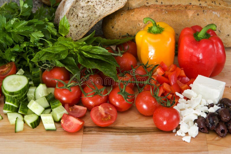 Fresh ingredients for greek salad on a cutting board. Fresh ingredients for greek salad on a cutting board