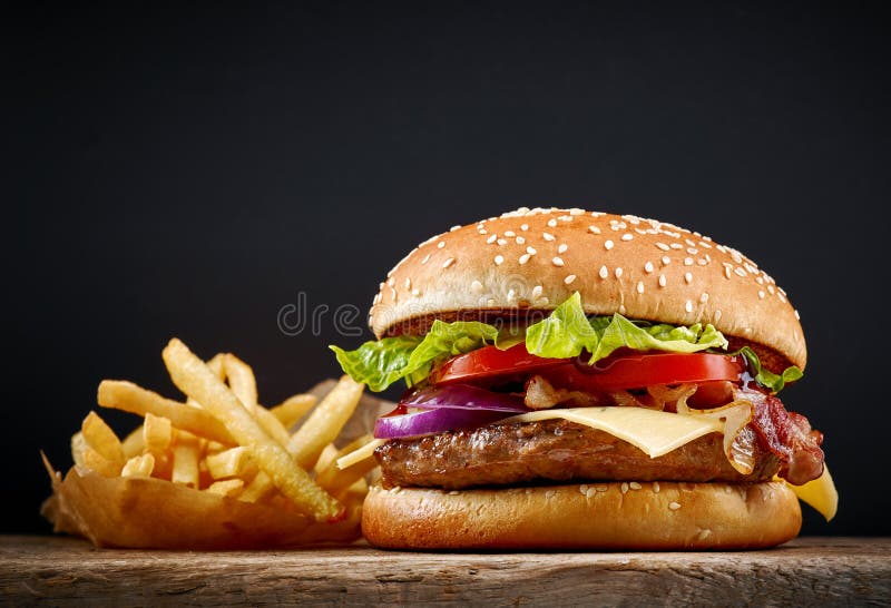 Fresh tasty burger and french fries on wooden table. Fresh tasty burger and french fries on wooden table