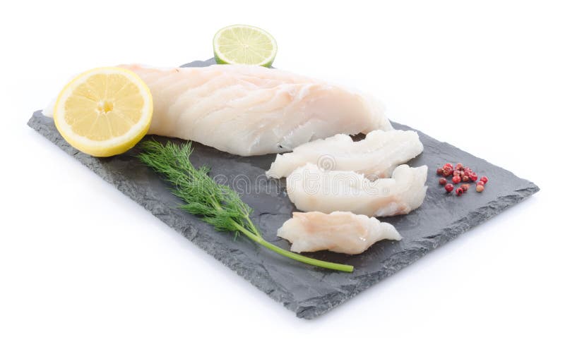 Fresh raw cod fillet on a slate plate, isolated on white. Fresh raw cod fillet on a slate plate, isolated on white