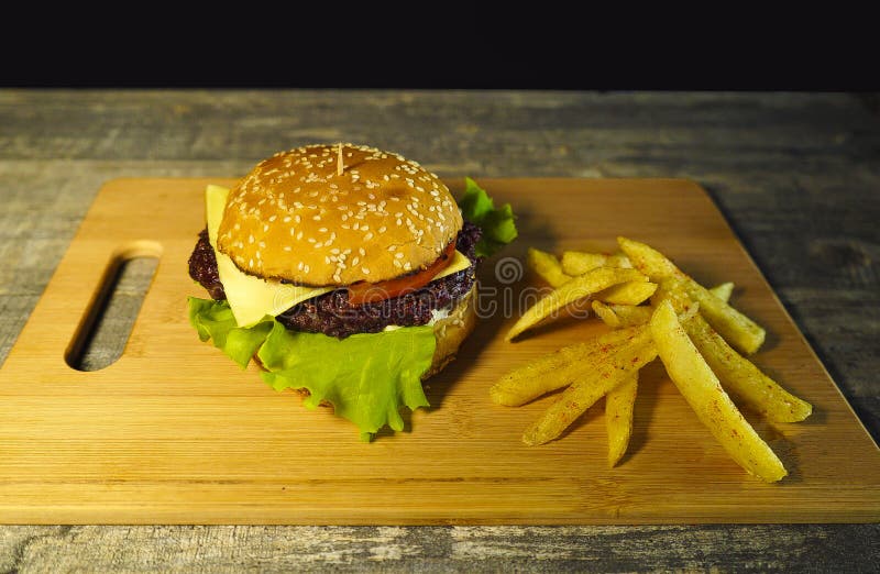 Ny varm hamburgare på en skärbräda som lagar mat arkivbilder Ny varm hamburgare på en skärbräda som lagar mat arkivbilder