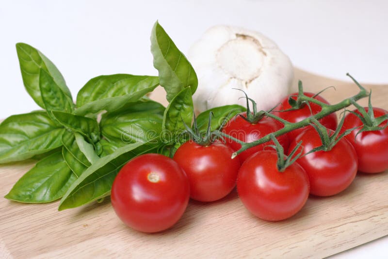 Tomatoes, basil, and garlic, ingredients for Italian cooking. Tomatoes, basil, and garlic, ingredients for Italian cooking