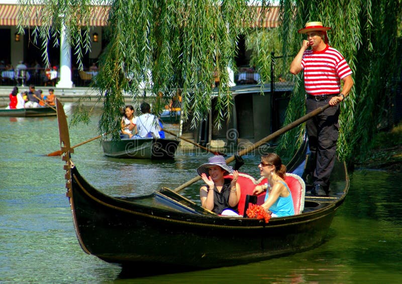Visitors enjoy a ride on the Central Park Boating Lake in an authentic Venetian gondola complete with a gondolier wearing a traditional red and white striped jersey and straw hat. Visitors enjoy a ride on the Central Park Boating Lake in an authentic Venetian gondola complete with a gondolier wearing a traditional red and white striped jersey and straw hat