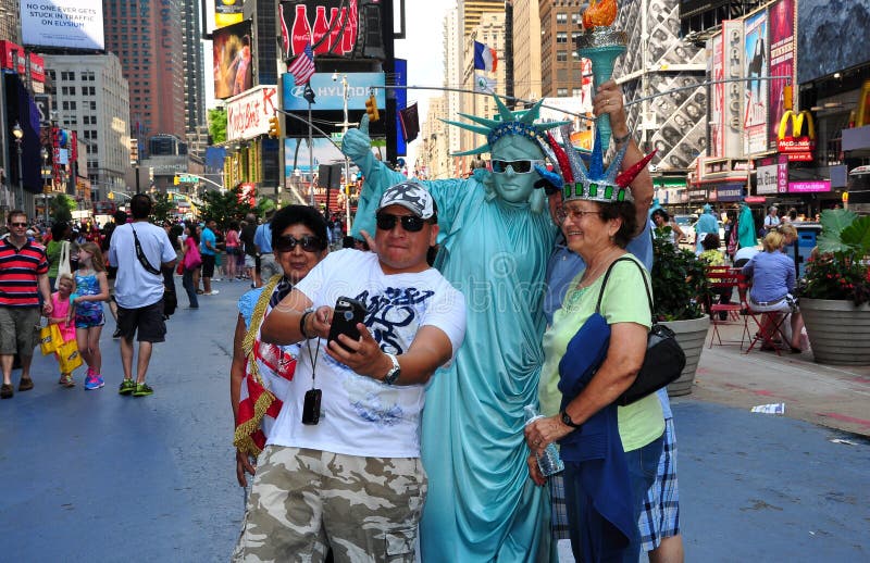 Bethany McNew, 24, from Tampa, mimics the pose of the Statue of Liberty as  she poses for a photo on Liberty Island | MiNDFOOD