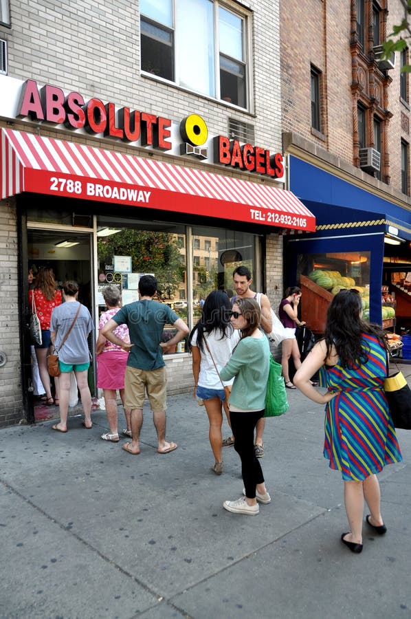 People wait patiently in a queue at the super popular Absolute Bagels restaurant on Broadway near NYC's Columbia University to eat Sunday brunch or to buy bagels for take-out. People wait patiently in a queue at the super popular Absolute Bagels restaurant on Broadway near NYC's Columbia University to eat Sunday brunch or to buy bagels for take-out.