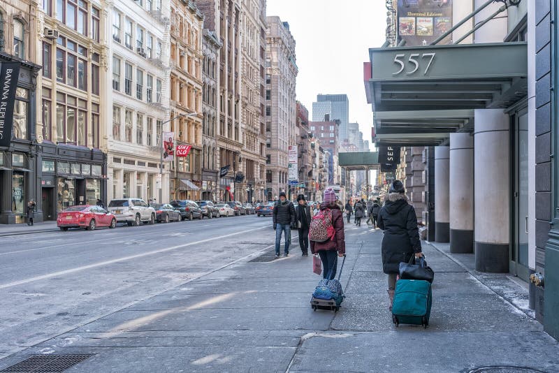 NYC/USA 02 JAN 2018 - People walking on New York street with suitcases. royalty free stock photos NYC/USA 02 JAN 2018 - People walking on New York street with suitcases. royalty free stock photos