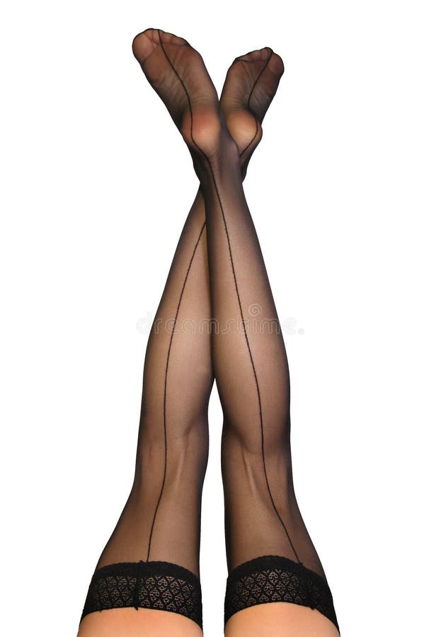 Female legs wearing sexy, old-fashioned black nylons with seams against a white background. Female legs wearing sexy, old-fashioned black nylons with seams against a white background.