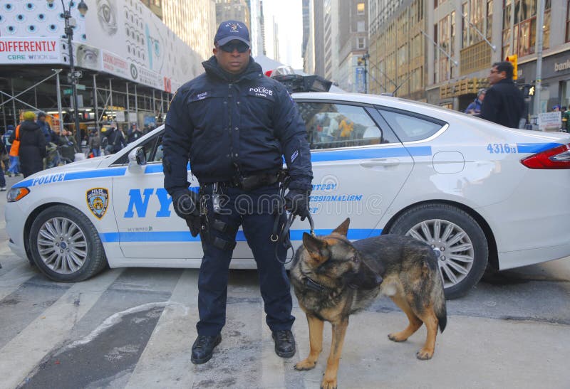 NYPD transit bureau K-9 police officer and K-9 German Shepherd providing security on Broadway during Super Bowl XLVIII week