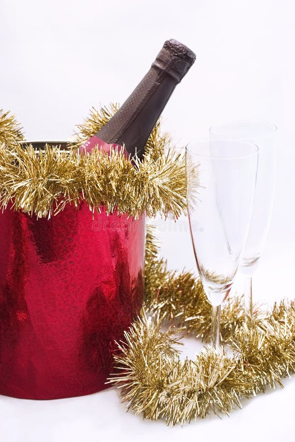 Bottle of Champagne in a bucket and two goblets for christmas (new year) celebration on white background. Bottle of Champagne in a bucket and two goblets for christmas (new year) celebration on white background