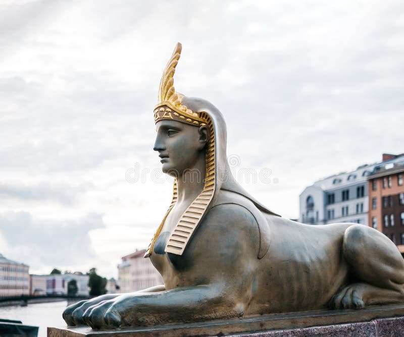 Nära skulpturen av sfinx på egyptiska bron. i bakgrunden är floden i samband med grundvattnet. arkivbild Nära skulpturen av sfinx på egyptiska bron. i bakgrunden är floden i samband med grundvattnet. arkivbild
