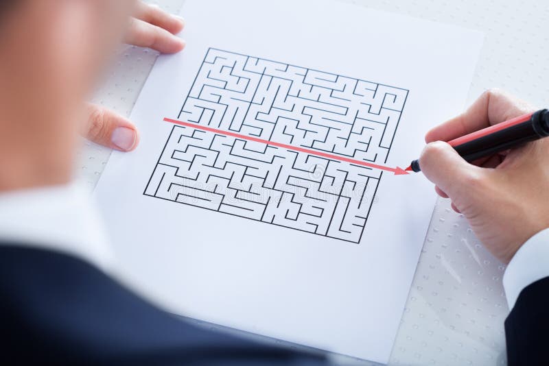 Businessman Solving Maze Puzzle With Red Pen. Businessman Solving Maze Puzzle With Red Pen