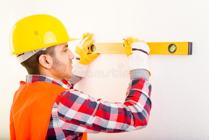 Construction worker using a water level. Construction worker using a water level