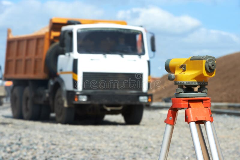 Surveying measuring equipment level theodolite on tripod at construction building area site. Surveying measuring equipment level theodolite on tripod at construction building area site
