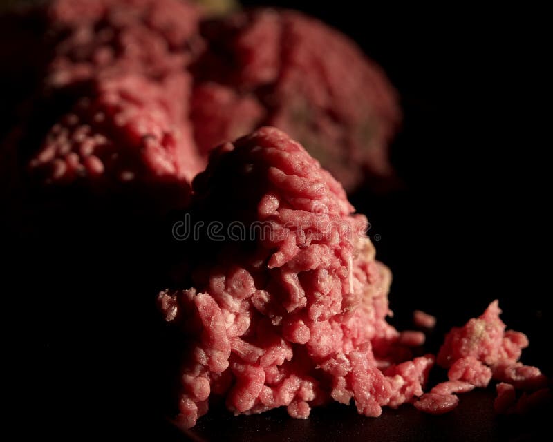 Fresh ground beef on a tray in the kitchen. The only light source is the sun coming in through the window. Fresh ground beef on a tray in the kitchen. The only light source is the sun coming in through the window.