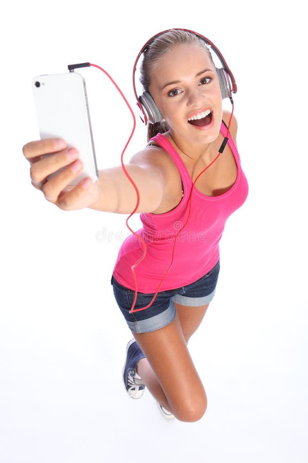 O adolescente 'sexy' feliz tem o divertimento da música com telefone imagens de stock O adolescente 'sexy' feliz tem o divertimento da música com telefone imagens de stock