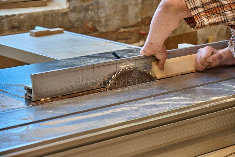 O artesão da colheita que corta a madeira com tabela viu imagens de stock O artesão da colheita que corta a madeira com tabela viu imagens de stock