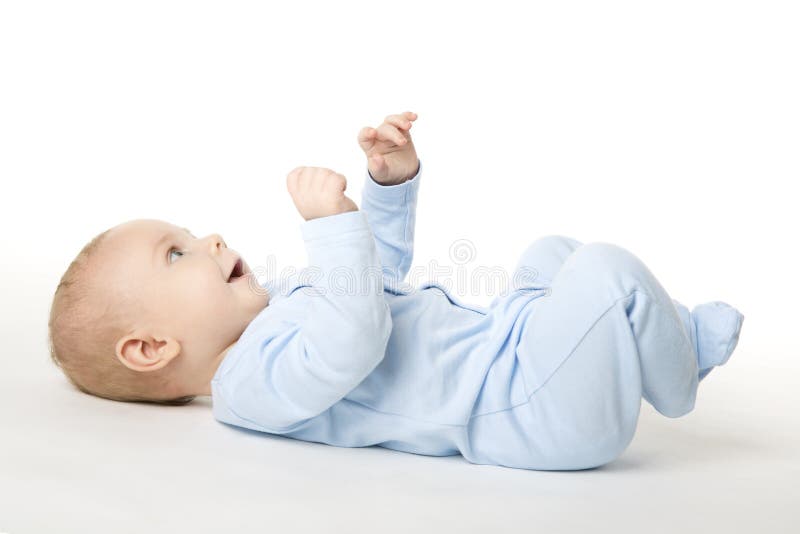 O bebê encontrando-se sobre traseiro, criança infantil feliz vestiu-se no Bodysuit azul
