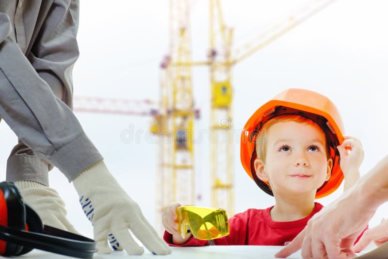 O conceito, construtores está discutindo com a criança sobre o desenho Local da cidade da construção do equipamento de proteção d imagens de stock royalty free O conceito, construtores está discutindo com a criança sobre o desenho Local da cidade da construção do equipamento de proteção d imagens de stock royalty free