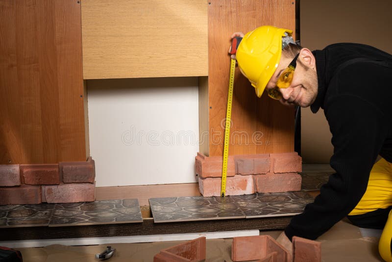 While measuring with a pull-out measure, a manual worker found time to smile and enjoy the job he is doing. While measuring with a pull-out measure, a manual worker found time to smile and enjoy the job he is doing.