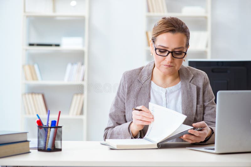 O empregado da mulher de negócios que trabalha no escritório foto de stock O empregado da mulher de negócios que trabalha no escritório foto de stock